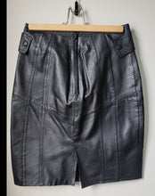 Load image into Gallery viewer, Back of 1980's style black pleather skirt with buttons at hips