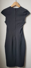 Load image into Gallery viewer, Back of women's H&M black fitted dress with capped shoulders size 2