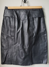 Load image into Gallery viewer, Front of 1980&#39;s style black pleather skirt 
