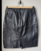 Load image into Gallery viewer, Back of 1980&#39;s style black pleather skirt with buttons at hips
