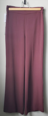 Front view of Babaton Lincoln pants burgundy colour Long inseam, wide pant leg, size 4. 