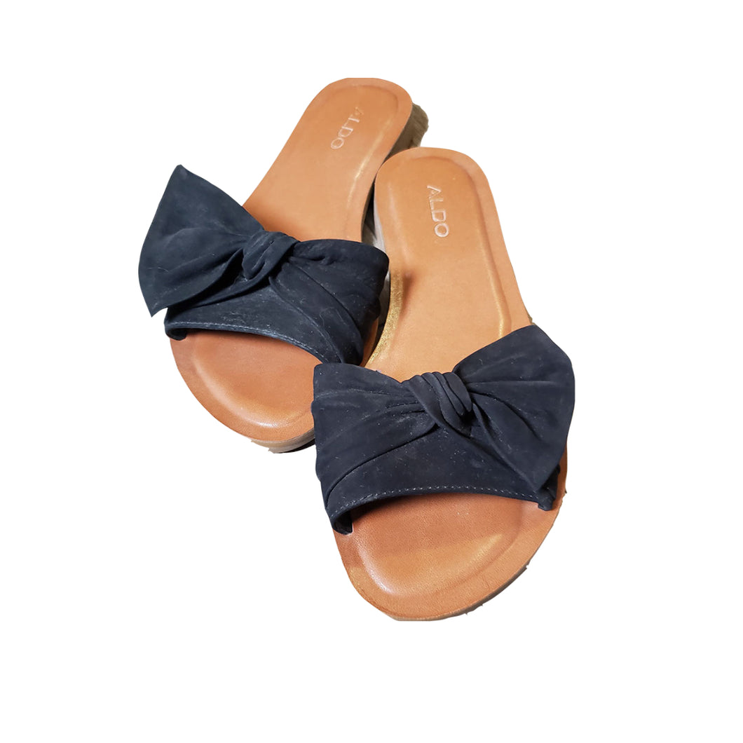 Women's Aldo slip on slides sandals with black bows and flat heel.